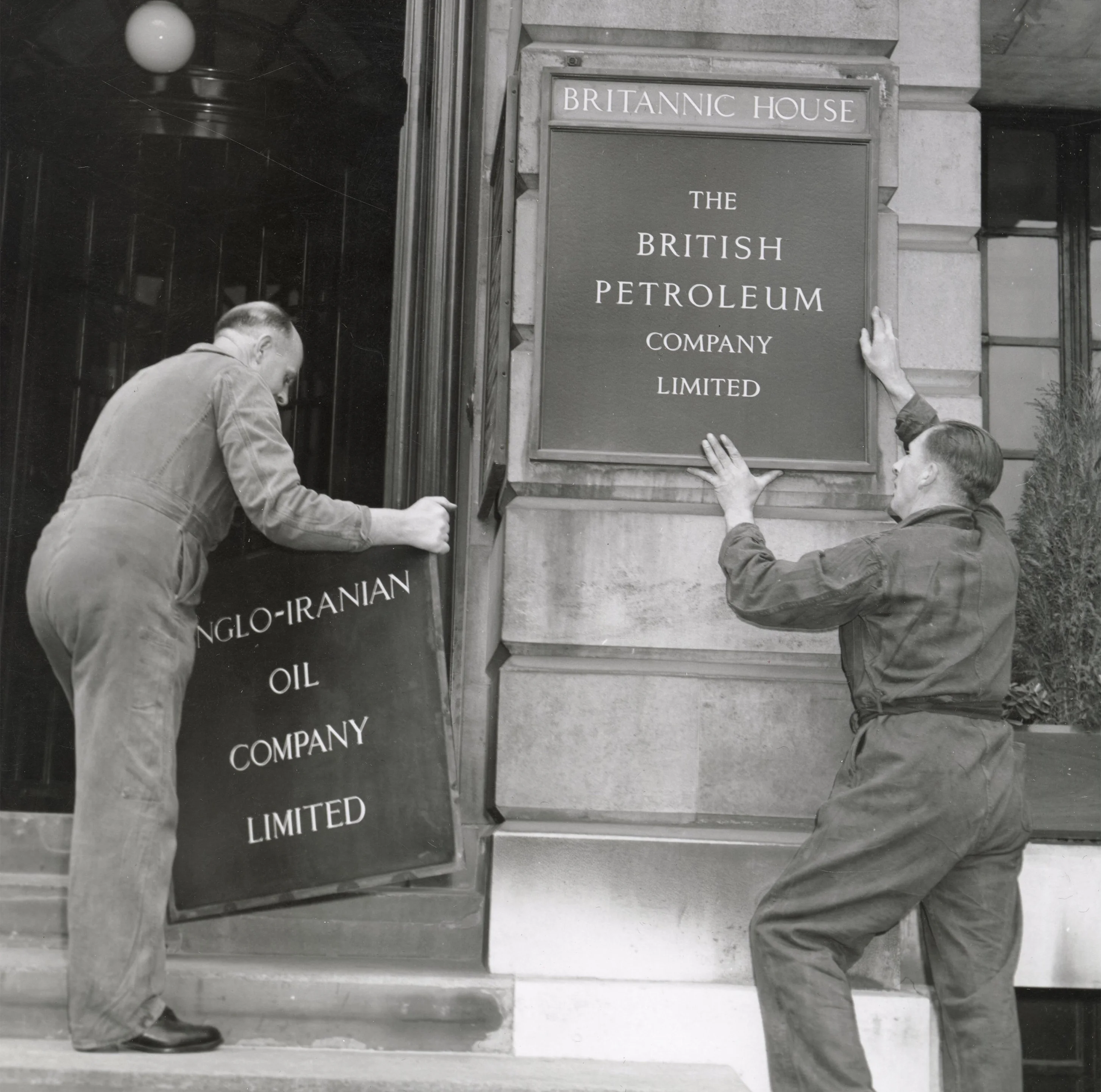 Fixing the company’s new name plate on its headquarters at Britannic House in London, December 1954