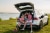 Family sitting in the boot of their electric car