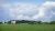 Red barn and field below dramatic cloudscape